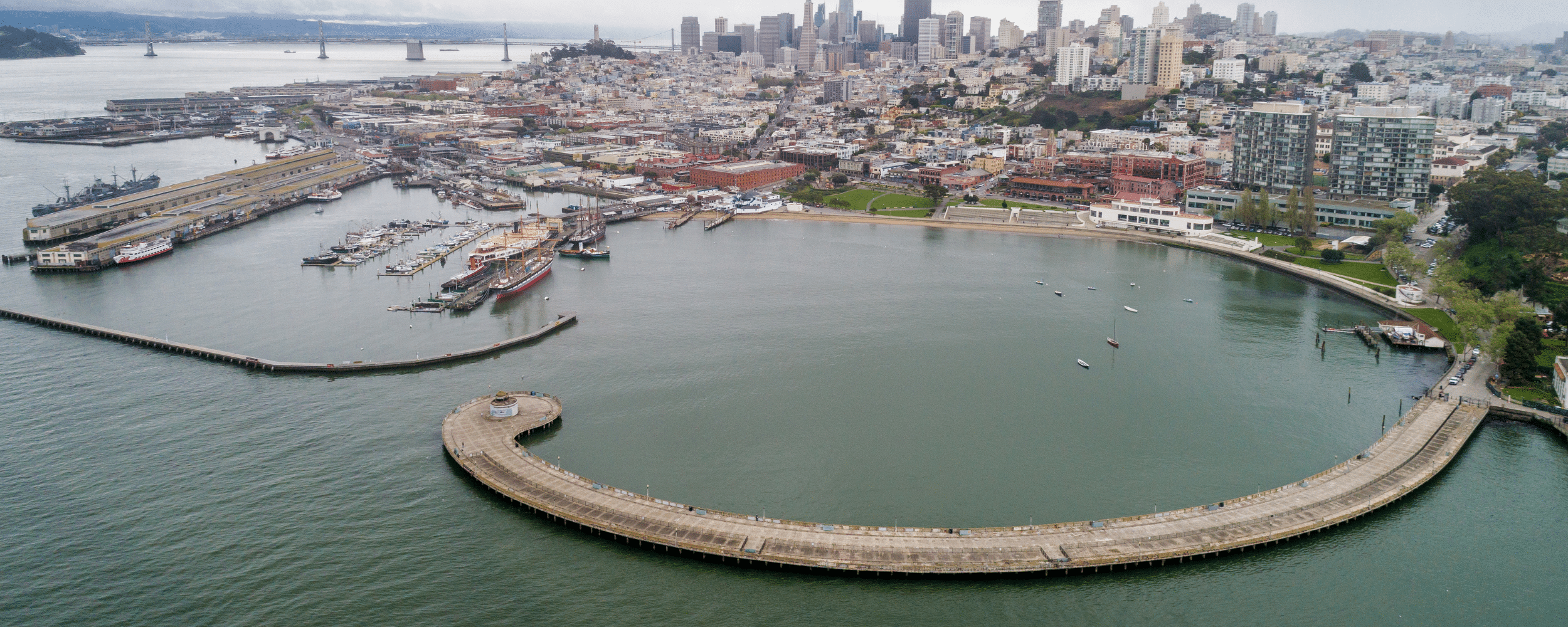 an ariel view of the aquatic park cove. ships, boats and people.