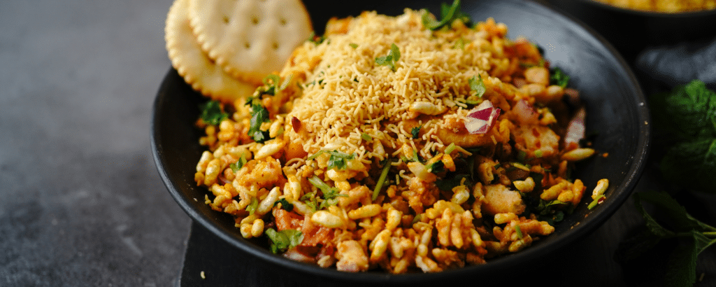Must try food items at Khau Galli, bhel puri topped with sev and two biscuits.