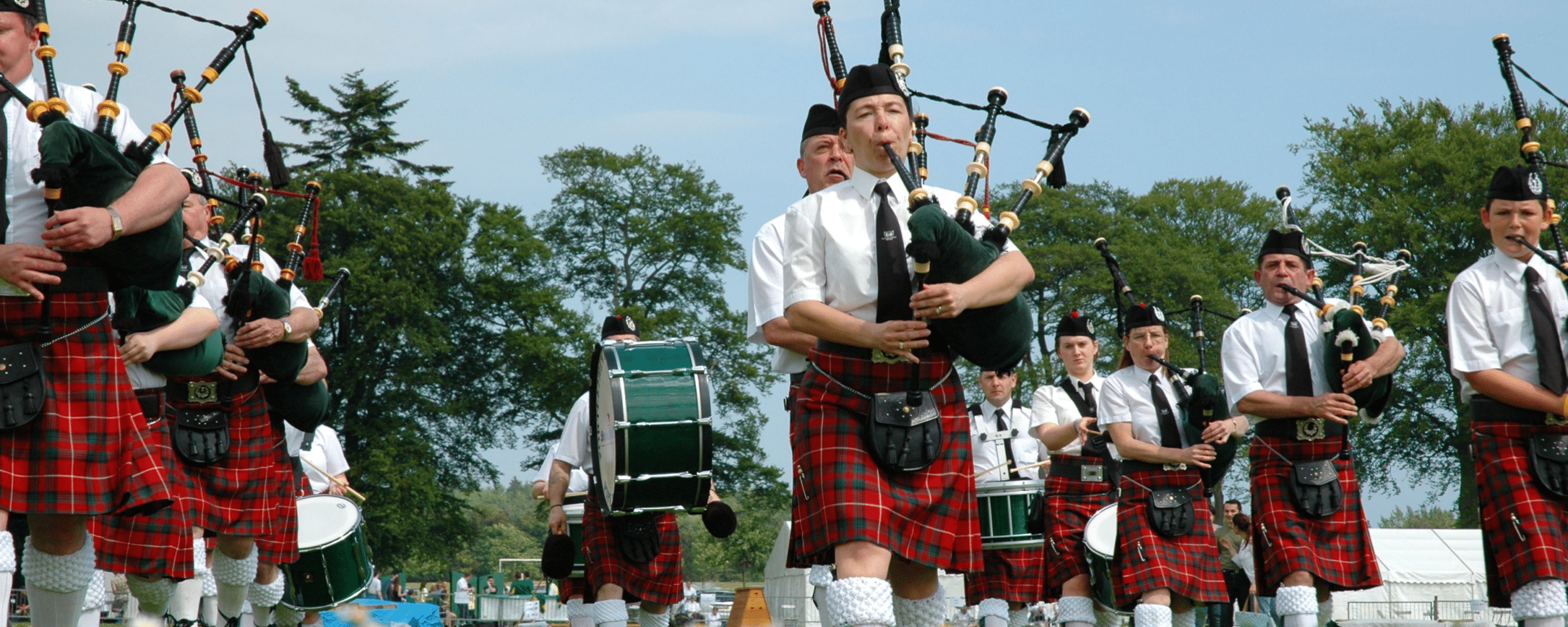 scottish bagpipers in their traditional attire performing at a music festival