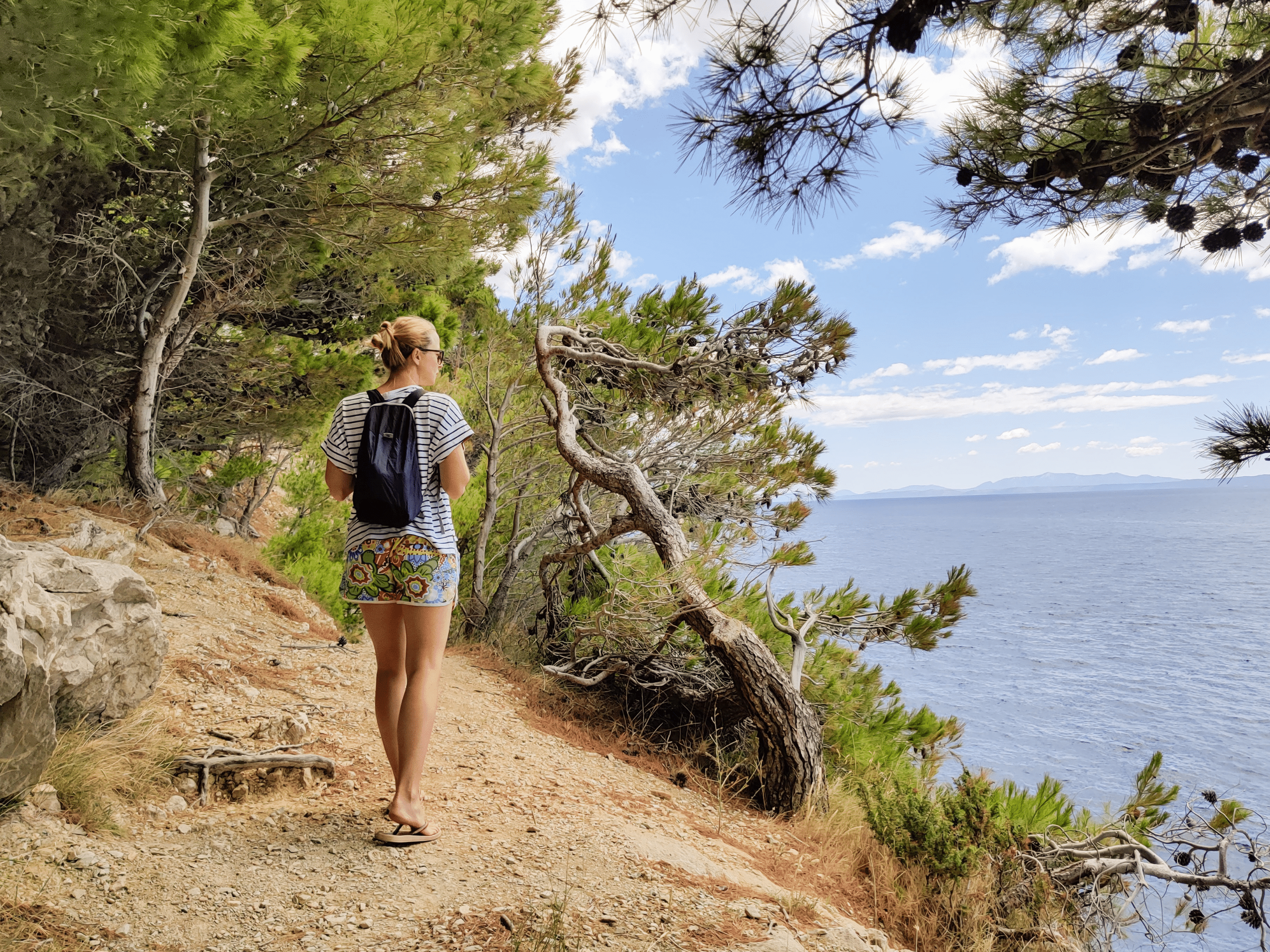 a female tourist hiking along the coastal trail