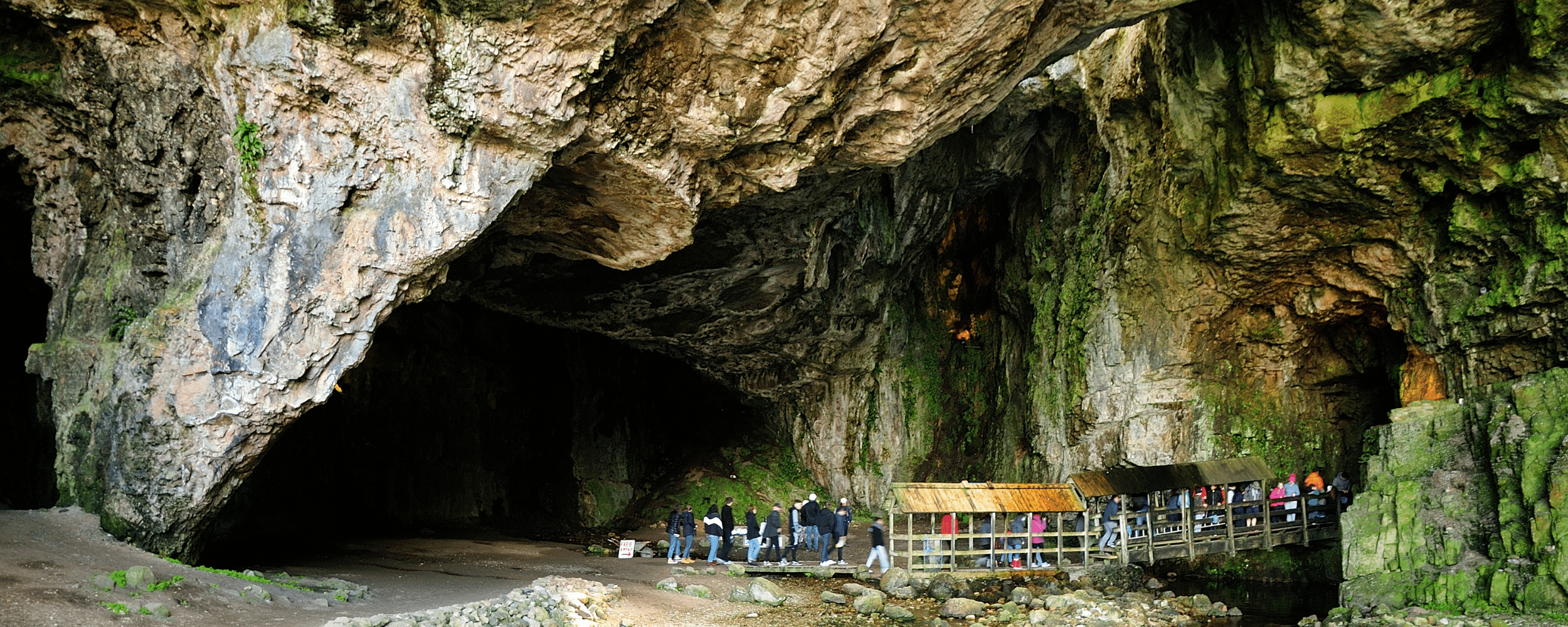 people standing in queue at the entrance of smoo cave