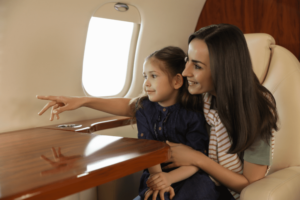 mother and daughter sitting together inside a flight