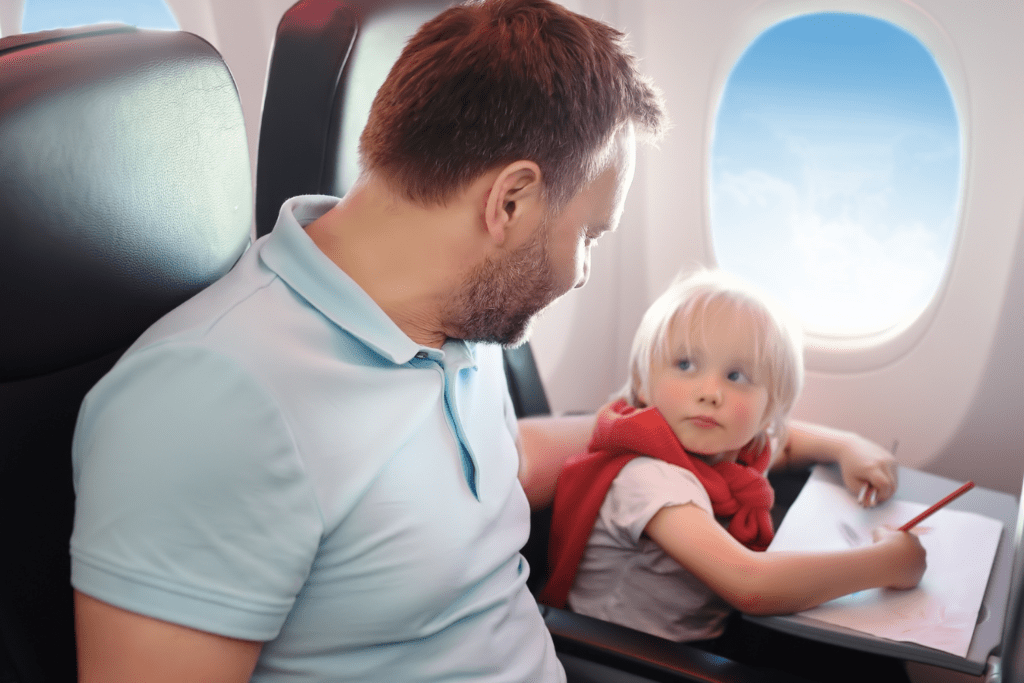 a father and son sitting together inside spirit flight