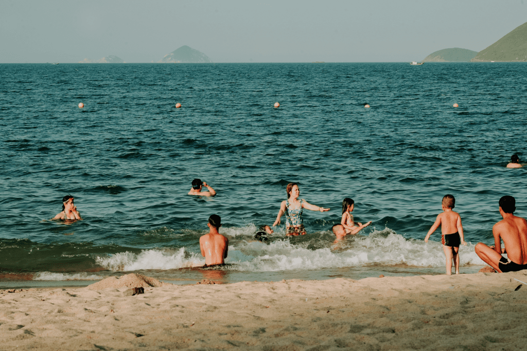 Many men, women and children swimming in the beach waters of Libertad El Salvador.